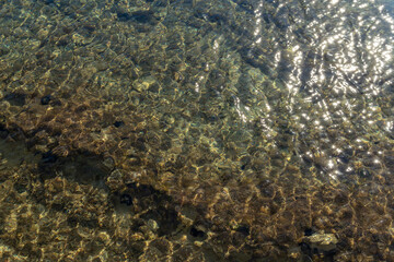 Fototapeta na wymiar Texture of the Mediterranean Sea on a sunny morning with clean and clear water