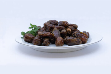 pile of dates with green leaf garnish