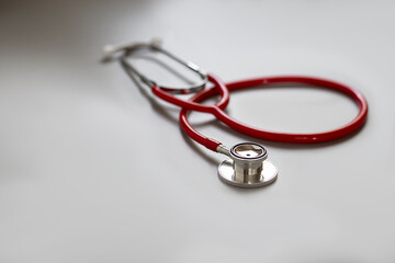 red stethoscope on gray background ,health care concept.