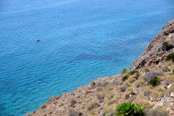 Cabo de Gata, Almeria, September 4, 2020, Kayak navigates the crystal clear waters of this Cabo de Gata-Nijar Natural Park, Mediterranean Sea, Andalusia, Spain