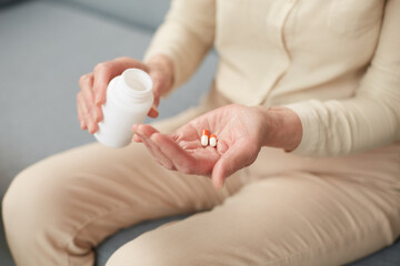 Pills in a senior's hands. Painful old age. Caring for the health of the elderly