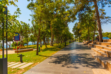 Naklejka premium ANTALYA, TURKEY: Trees and roads on the territory of Konyaalti beach in sunny summer in Antalya.