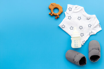 Baby accessories with bodysuit and shoes. Flat lay
