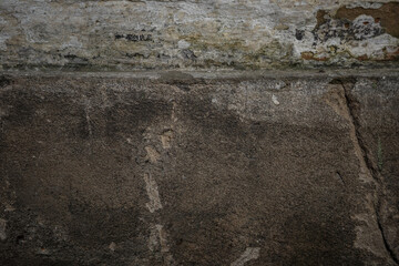 White painted old brick wall with red cracked bricks.