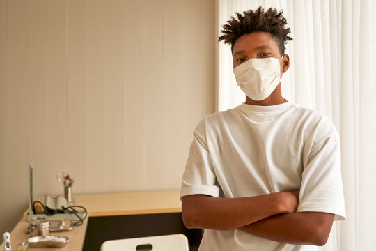 African american male portrait with face mask in health care clinic for protect covid19