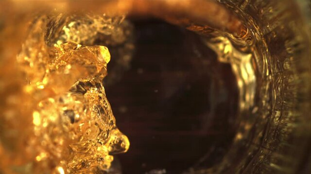 Super slow motion in the glass pours beer whirlpool with air bubbles. Macro background. Filmed on a high-speed camera at 1000 fps.High quality FullHD footage