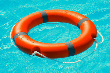 Life ring floating on top of sunny blue water. Life ring in swimming pool