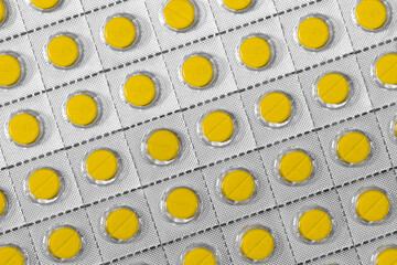 yellow pills in foil package - background - 445168279