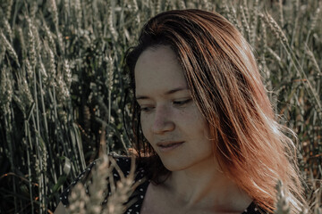 Russian girl in a field with wheat - here she is real freedom