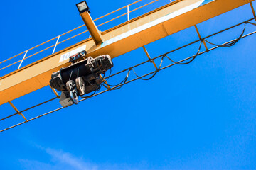 Overhead crane on the walk beam outdoor factory and blue sky
