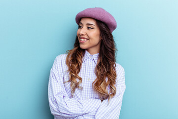 Young mexican woman isolated on blue background smiling confident with crossed arms.