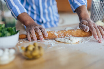 Adult man, making delicious food in his restaurant.