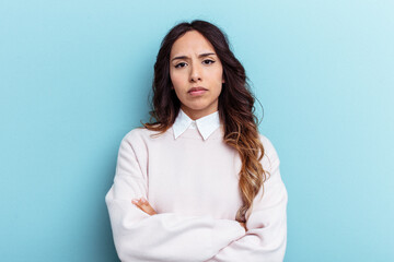 Young mexican woman isolated on blue background who is bored, fatigued and need a relax day.