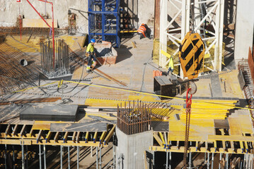 Construction site of a tall building, work on the reinforcement of a skyscraper  - obrazy, fototapety, plakaty