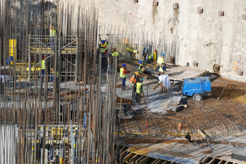 Construction site of a high building, work on reinforcement of foundations  - obrazy, fototapety, plakaty