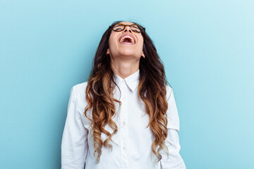 Young mexican woman isolated on blue background relaxed and happy laughing, neck stretched showing teeth.