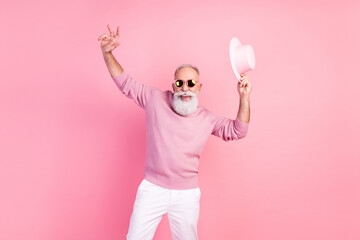 Photo of handsome optimistic grey hair mature man dance wear eyewear cap sweater isolated on pink background