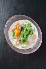 Thai style cold chendol bobo chacha green ruby dessert in glass on wood background asian dessert menu