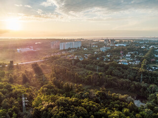 Obraz premium Aerial sunrise morning flight. Cityscape in greenery with fog at dawn in nice pastel light. View on Sokilnyky with Derevianka st bridge across Sarzhyn Yar in Kharkiv city.