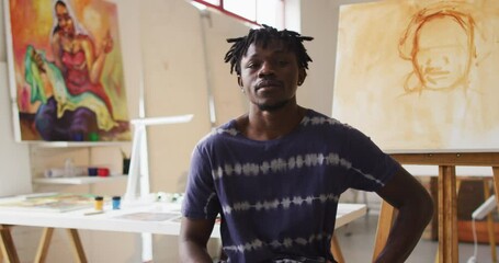 Portrait of smiling african american male painter in artist studio - Powered by Adobe