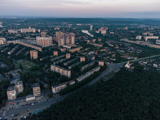 Fototapeta na wymiar Aerial morning view Kharkiv city Pavlove Pole district Derevianka St. Multistory buildings new residential area near forest in summer dawn light