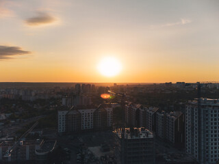 Naklejka premium Aerial sunset view of Kharkiv city center new buildings near Park. Residential multistory houses with scenic dark moody sky