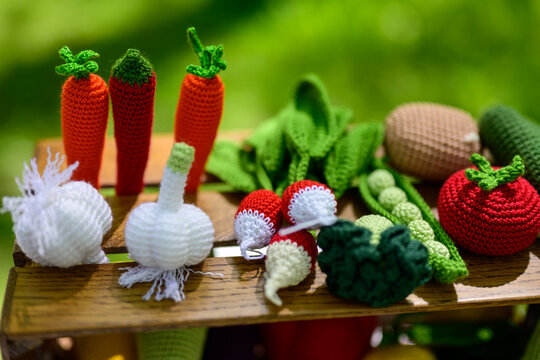 Photo knitted toys, colorful vegetables outdoors