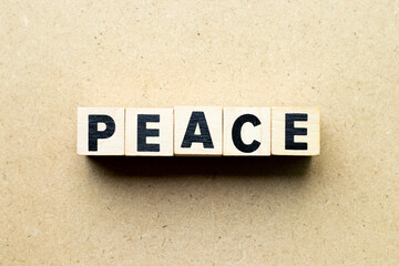 Alphabet letter block in word peace on wood background