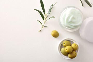 Olive moisturizing cream for skin on white table top