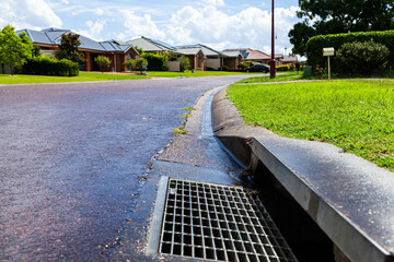 A Stormwater drain in gutter of suburban street