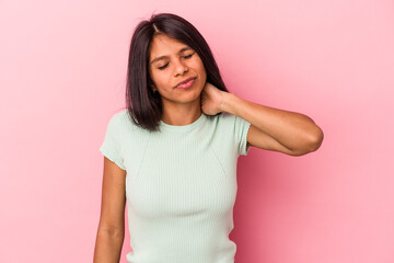 Fototapeta premium Young latin woman isolated on pink background having a neck pain due to stress, massaging and touching it with hand.