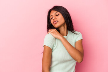 Young latin woman isolated on pink background having a shoulder pain.
