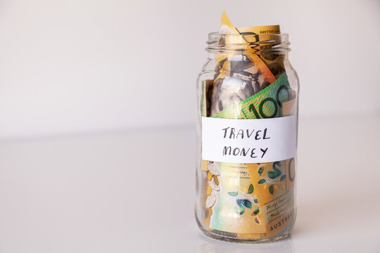 travel money in jar in white
