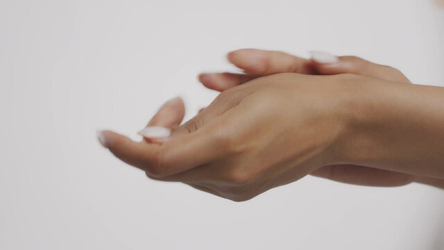 Skin nutrition. Unrecognizable black woman applying moisturizing body lotion on hands, using rich nourishing cream