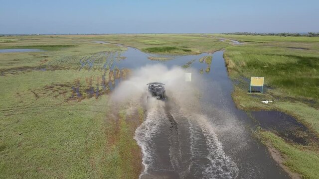 ATV across the field in the mud