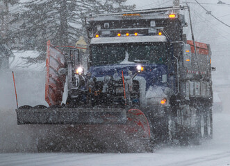 Close up of a snowplow clearing the road during a blizzard