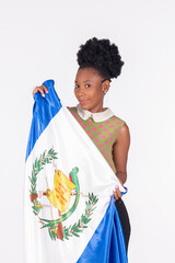 Cute latina woman holding the Guatemalan flag in front of her: Diversity concept.