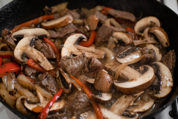 Close-up of frying pan with meat and portobello meal