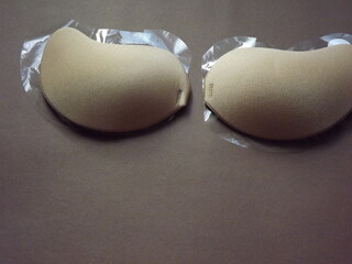 beige strapless bra close-up on different color backgrounds, size A. High quality photo
