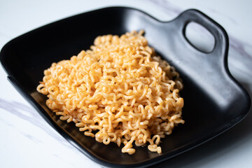 Korean instant noodles in a black plate