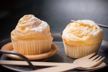 Vanilla cupcakes on a black background