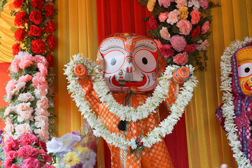 Idols of God Balaram. Lord Balaram , brother of Lord Jagannath is being worshipped with garlands...