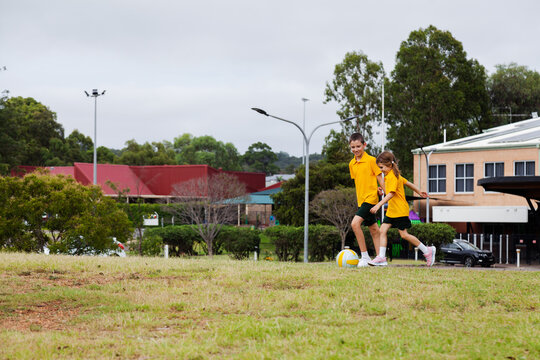 Australian primary school students running after a ball