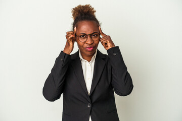 Young business african american woman isolated on white background focused on a task, keeping forefingers pointing head.