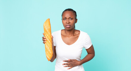 black african american adult woman holding a baguette