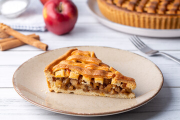 Homemade apple pie with red and green apples around