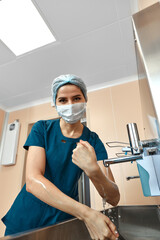 Fototapeta na wymiar Woman doctor, washing her hands close-up, in the preoperative unit, disinfection of hands, plastic surgery