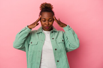 Young african american woman isolated on pink background touching temples and having headache.