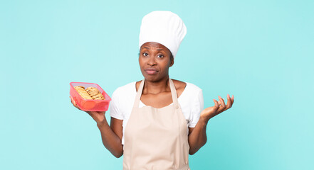 black african american adult chef woman with a tupperware