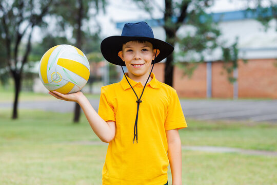 Aussie school boy with ball ready to play sports